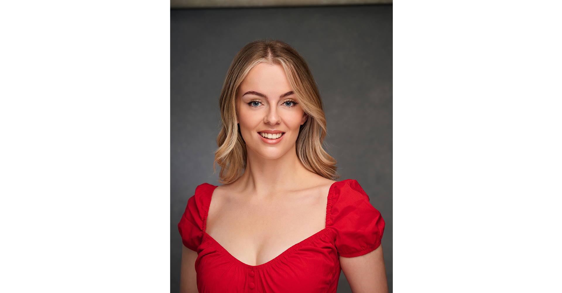 Lady with blond hair and a red dress head shot